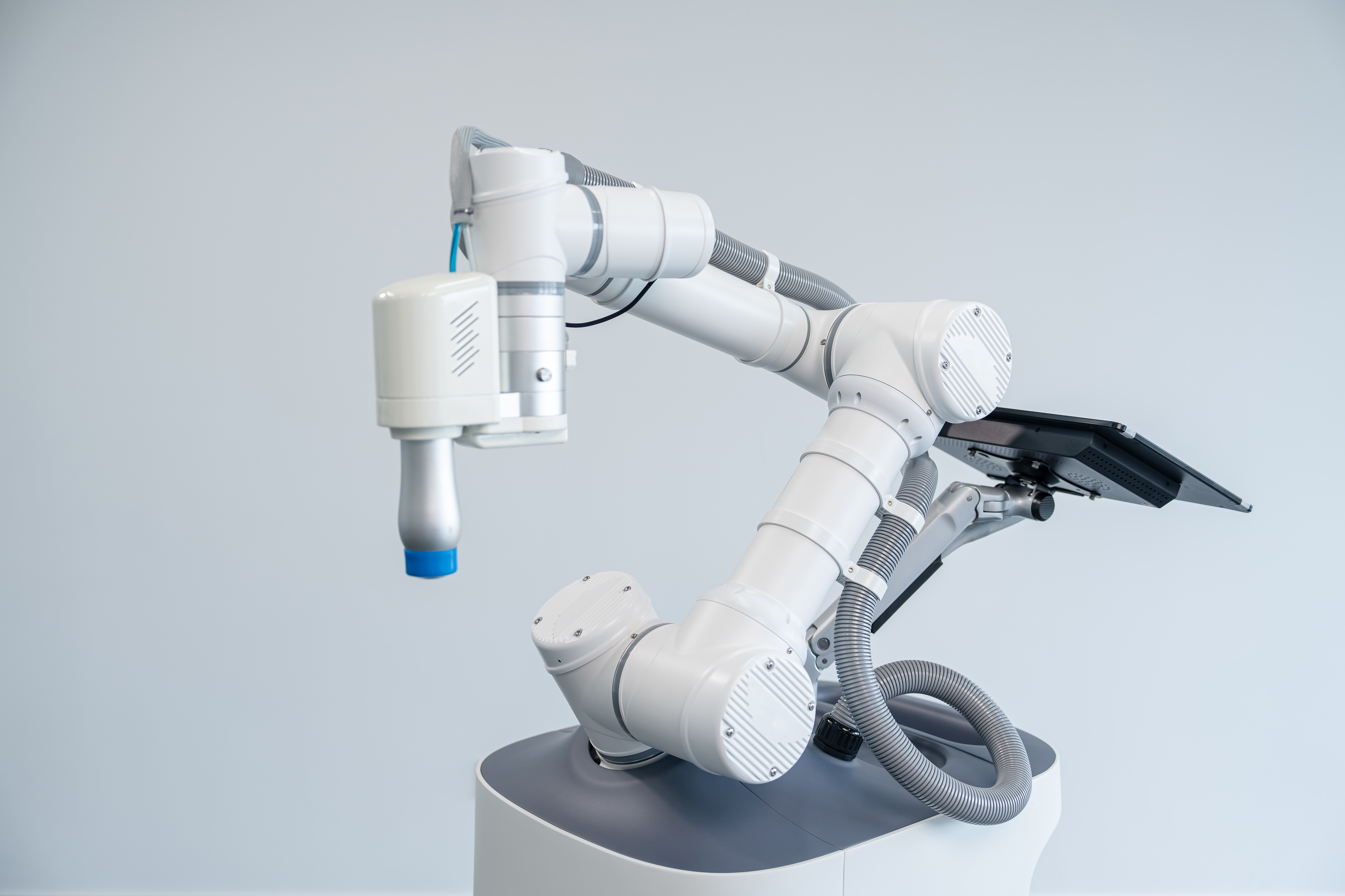 Close-up of the myosbot robotic arm, massage end effector and display